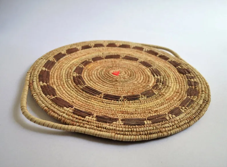 Tribal wall basket with goat leather decoration